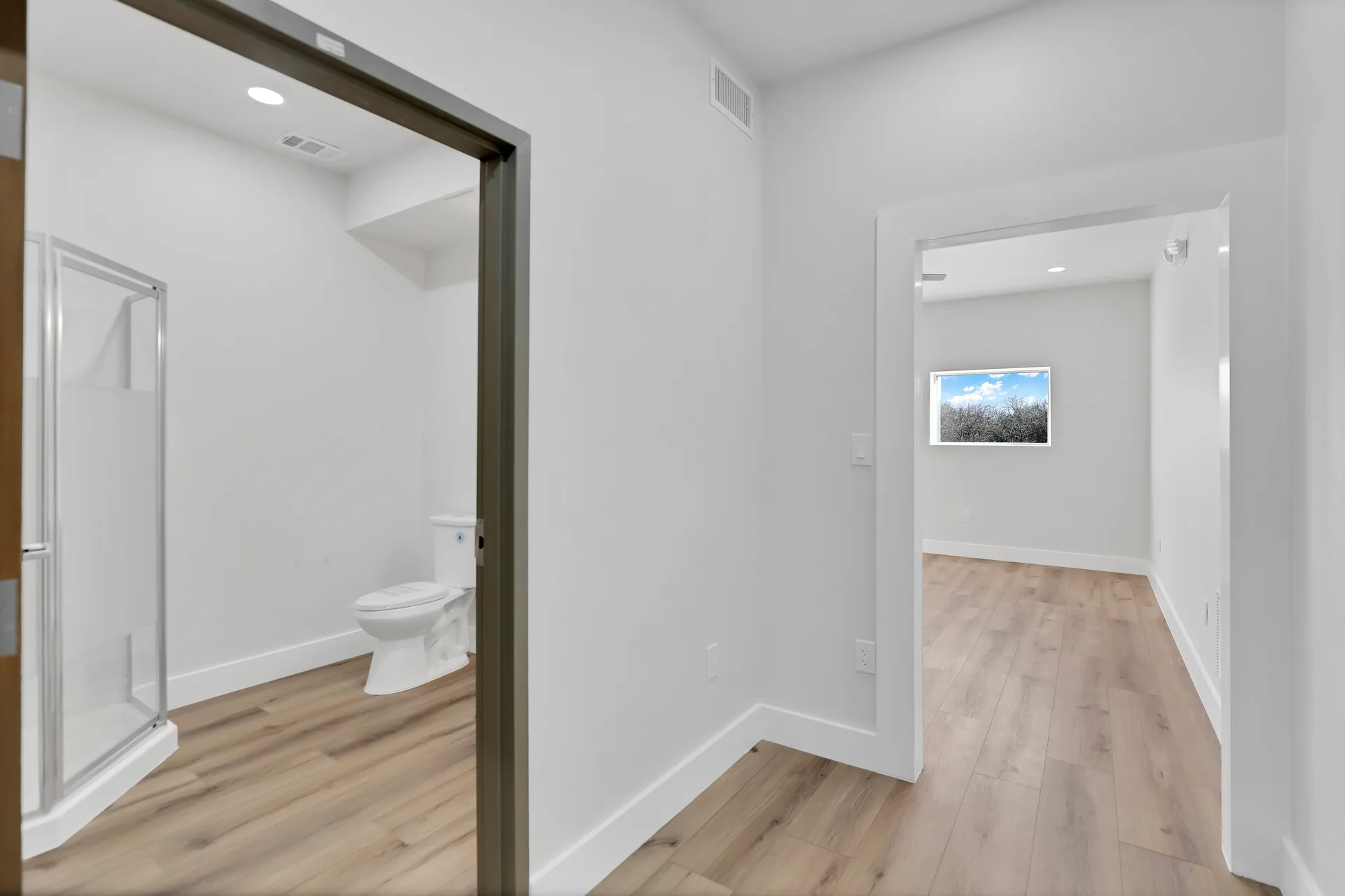 Interior amenity area showing restroom access with shower and adjacent finished office space